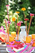 Colourful arrangement of flowers and orange candles