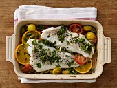 Oven baked cod with colourful tomatoes and oranges