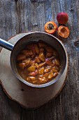 Apricots cooked with vanilla, cinnamon and maple syrup in a saucepan