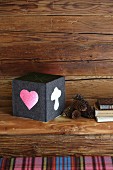 Hand-crafted, felt cube lampshade on wooden bench