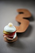 Pastrami sandwich with gherkin macaron, gherkin, tomato and BBQ sauce from the restaurant 'The Table' in Hamburg, Germany