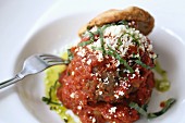 Large meatball with grated parmesan cheese and shredded basil