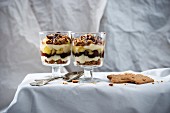 Vegan layered dessert with semolina cream, speculoos biscuits, apples and chocolate