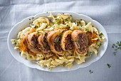 Cabbage rolls stuffed with beef on pasta with red vegetable sauce (vegan)