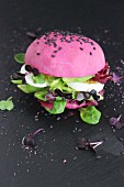 Pink burger with avocado and egg