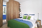 Alpine-style bedroom with blue and green accents and wooden elements
