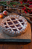 Linzer Torte (nut and jam layer cake) and bunches of holly berries