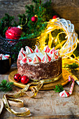 A Christmas cake on a wooden plate
