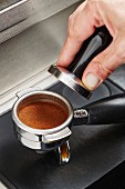 A coffee press with a tamper