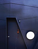 Designer entrance door in a dark facade