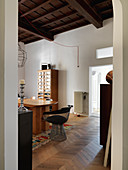 Delicate designer chair at chunky wooden table in dining room