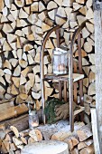 Old wooden sledge used as shelves in front of stacked firewood
