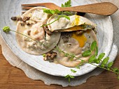 Giant ravioli filled with eggs and herbs with morel sauce