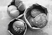 Various bread rolls in paper bags (seen from above)