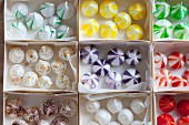 Small colourful meringue drops in boxes
