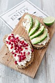 Seeded bread with cottage cheese, pomegranate seeds and avocado