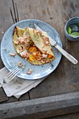 Pancakes with crab and yellow tomatoes