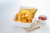 Chips and ketchup in takeaway cartons