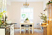 Festively decorated kitchen-dining room with diamond-patterned wallpaper