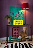 Red flowers in yellow-painted milk crate, Roman bust and turquoise painting
