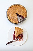 Sour Cherry Pie whole and sliced on a white plate