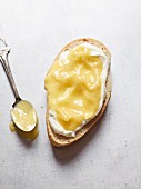 A slice of bread spread with lemon curd