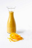 Butternut soup in a glass bottle with butternut noodles and space for text