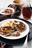 Pancakes with bananas, maple syrup and pecans