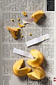 Fortune cookies, three whole and one smashed open