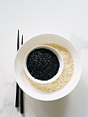 Black and white rice in separate bowls