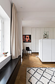 Storage space in white fitted cupboards and in central cabinets