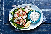 Fried cod with spinach, pomegranate and herb yogurt sauce