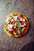 Pizza topped with cured ham, parmesan and red sorrel