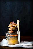 Duck liver in a glass jar with toasted bread slices