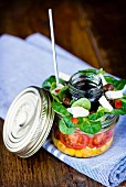 Lunch in a glass jar: corn salad, cherry tomatoes, lamb lettuce, goat's cheese and a balsamic dressing