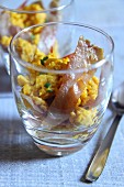 Scrambled eggs with bacon and chives in a glass