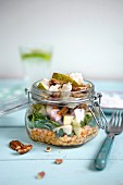 Lunch in a glass jar: goat's cheese, pear, rocket and red lentils
