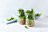 Layered buckwheat salad with leek, pepper and spinach in a jar