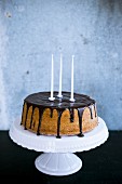 A birthday cake with chocolate glazing