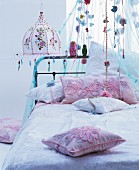 Romantic bed with canopy and hippy-style lamp