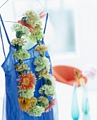 Necklace of flowers hung on blue dress