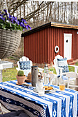 Tisch mit blau-weisser Tischdecke auf der Terrasse