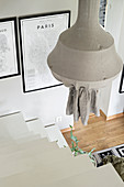 Pendant lamp and white staircase leading into living room