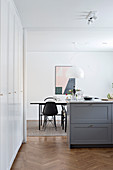 View through kitchen with fitted cupboards into dining room