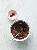 Melted chocolate in a bowl with a whisk