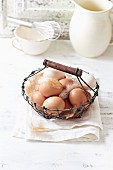 Organic eggs in a rustic basket