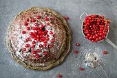 A chocolate cake with redcurrants (seen from above)
