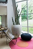 Butterfly chair and pouffe on round rug