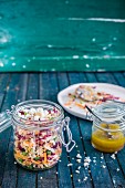 Quinoa and radish salad with mustard vinaigrette in a glass jar