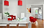 Red accents in white, modern loft apartment